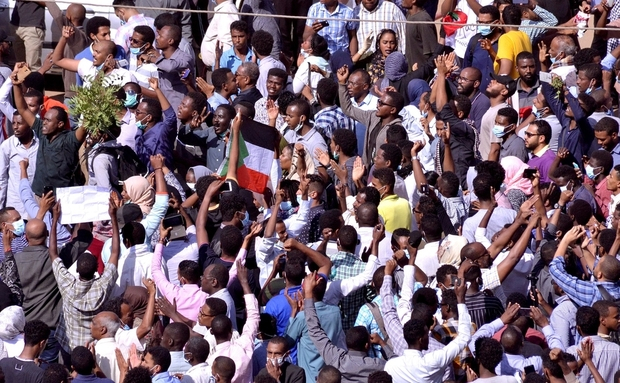 Sudanese demonstrators chant slogans as they march along the street during anti-government protests in Khartoum